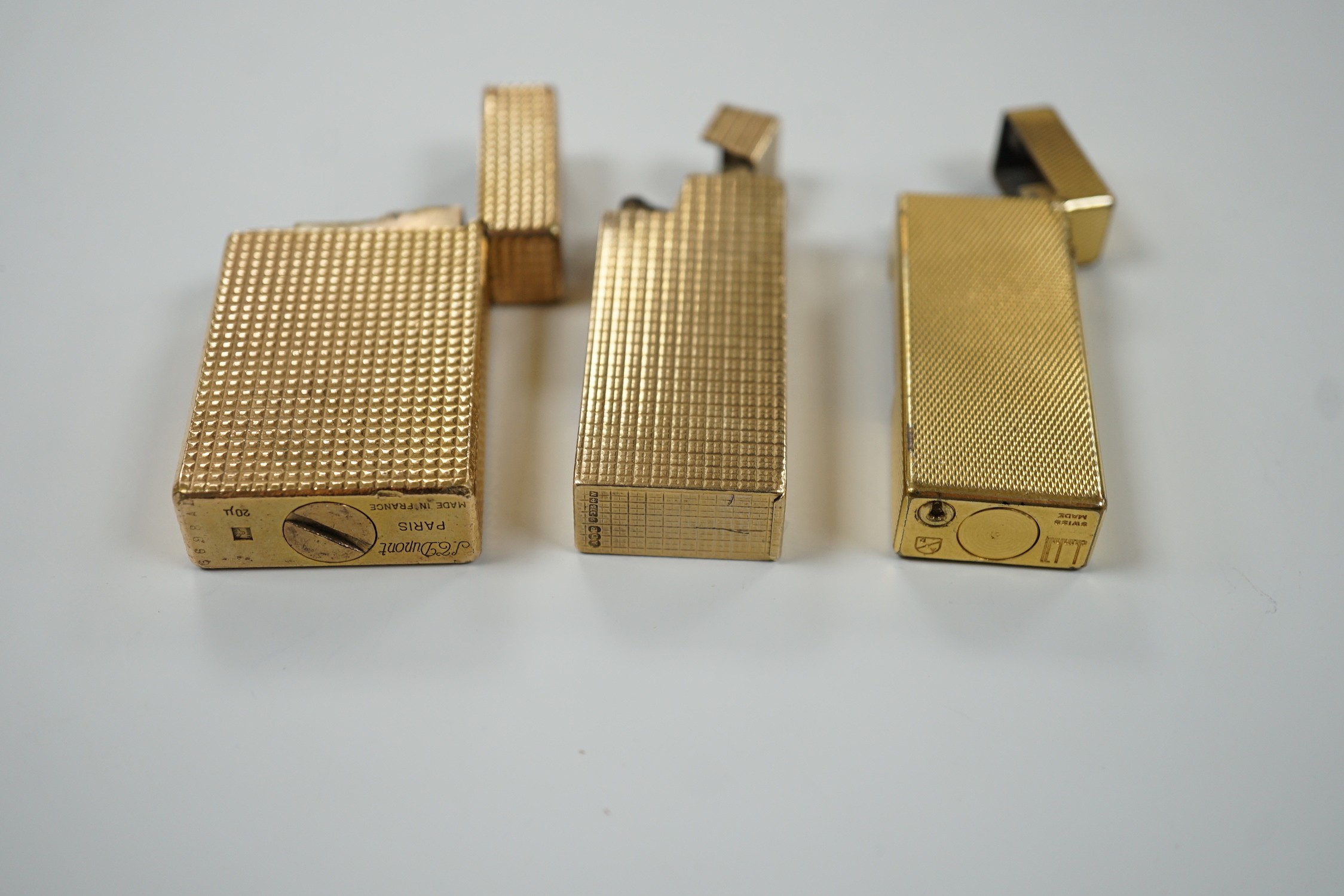 Three Dupont gilt metal lighters